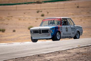Vintage BMW 2002 race car on track